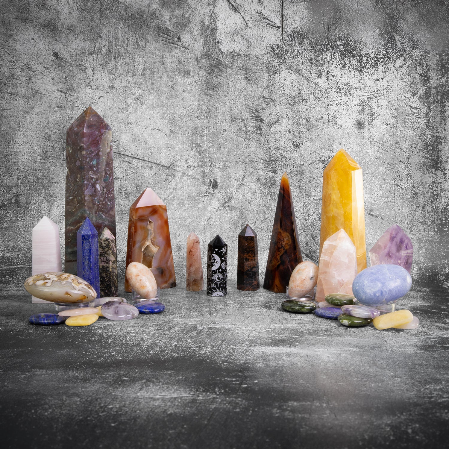 Crystal obelisks, palm stones, and worry stones in assorted gemstones for wholesale metaphysical and boutique retail collections
