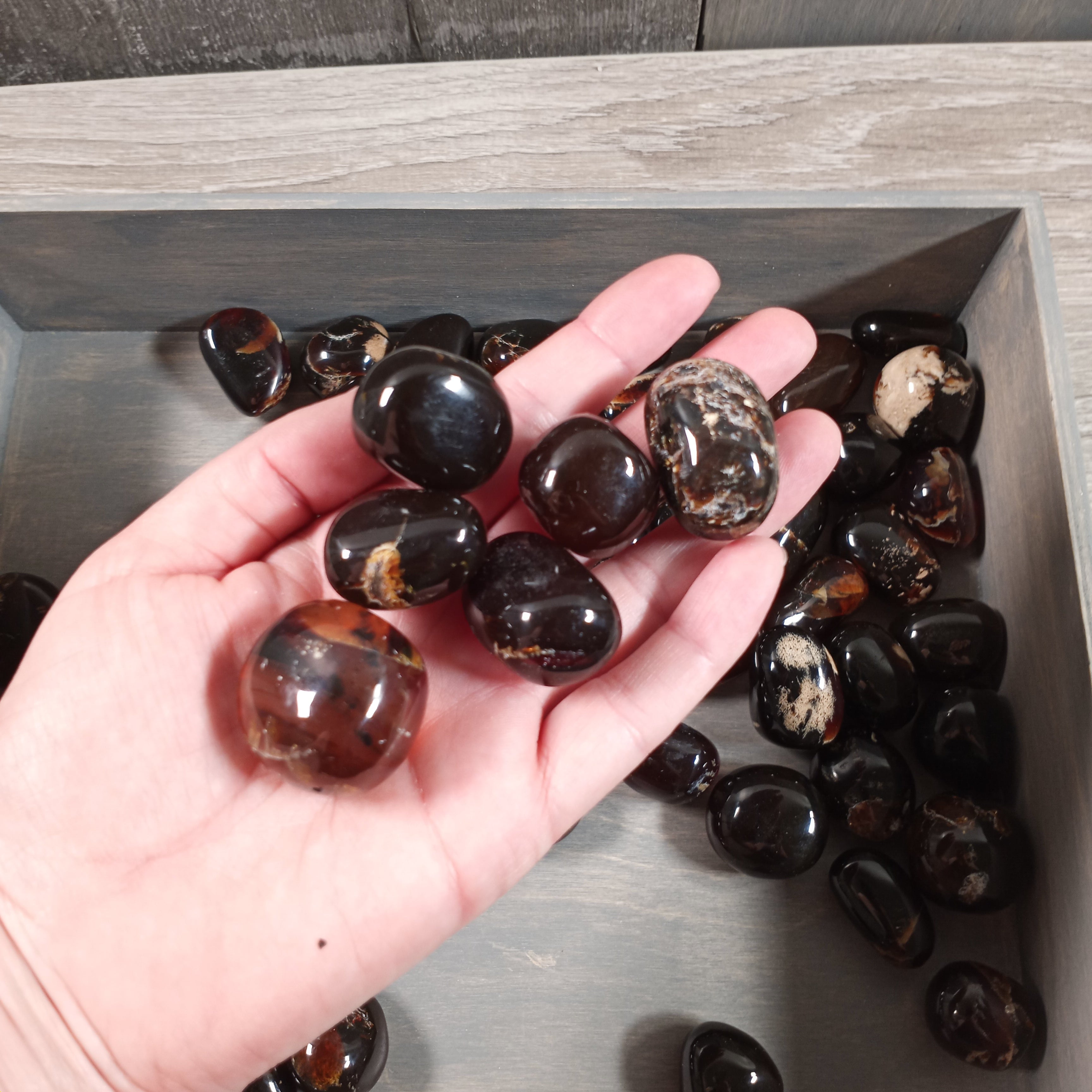 Polished black amber tumbled stones wholesale by the kilo