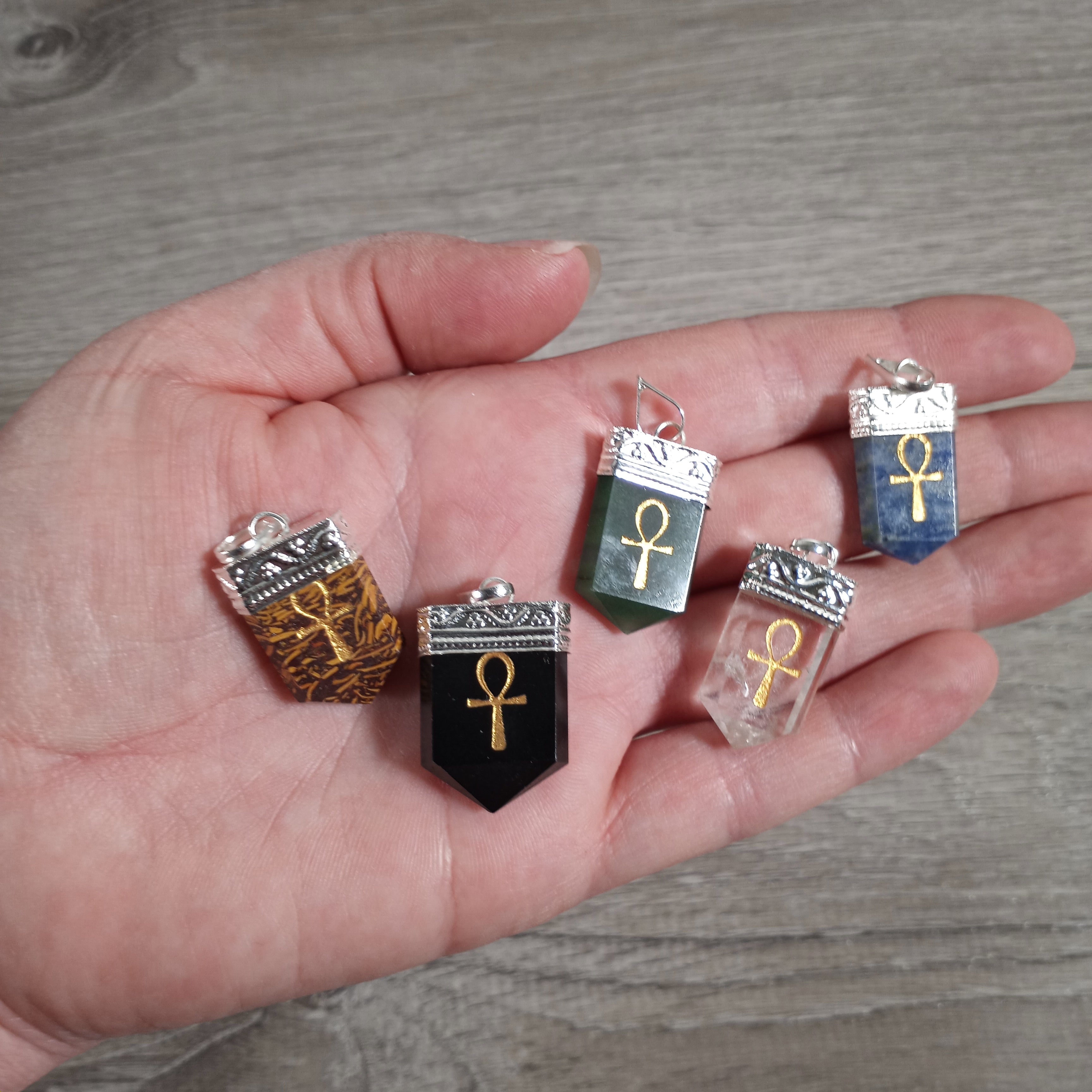 Silver pot metal gemstone pendants with etched designs for metaphysical shops.