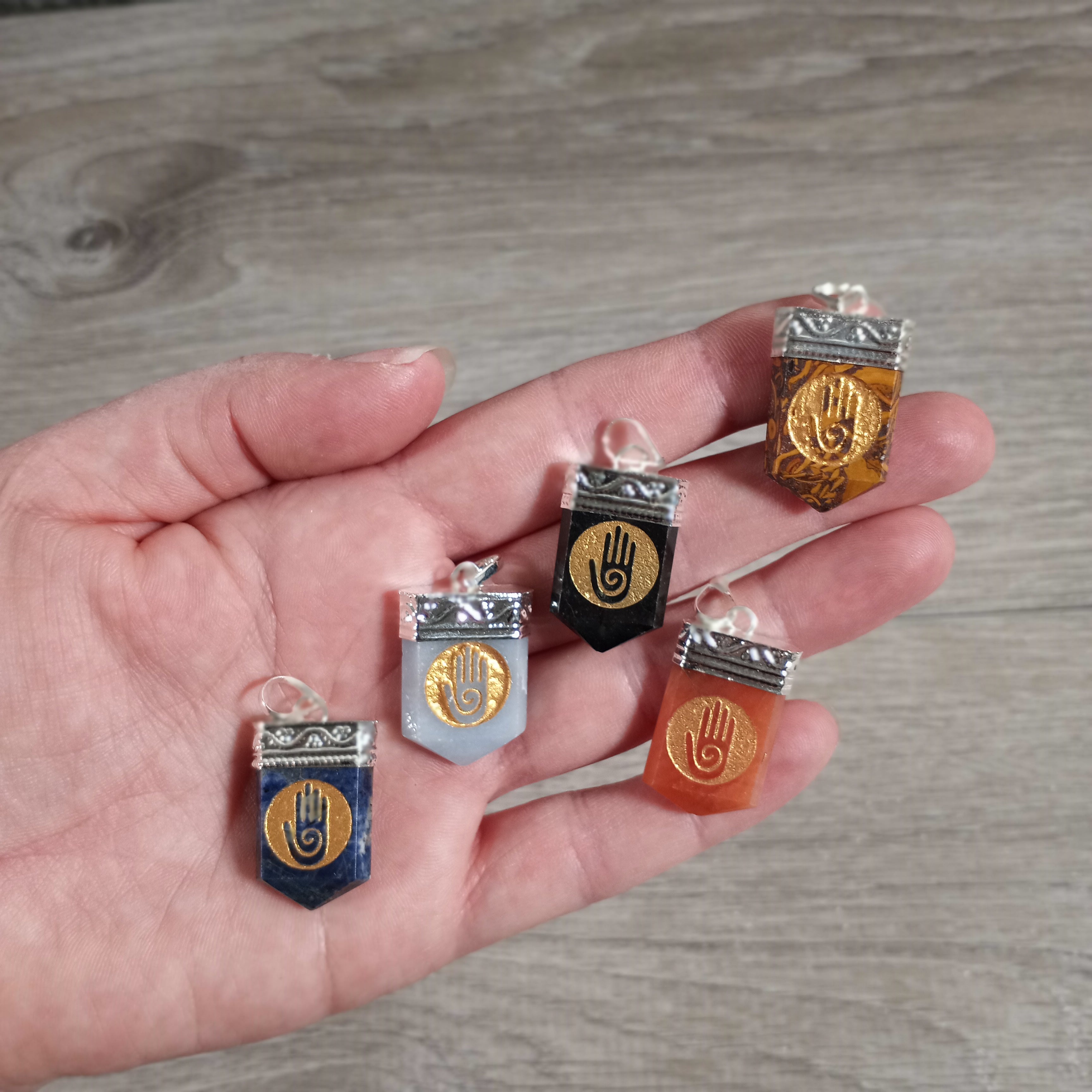 Close-up of gemstone pendant featuring spiritual etched designs for wholesale buyers.