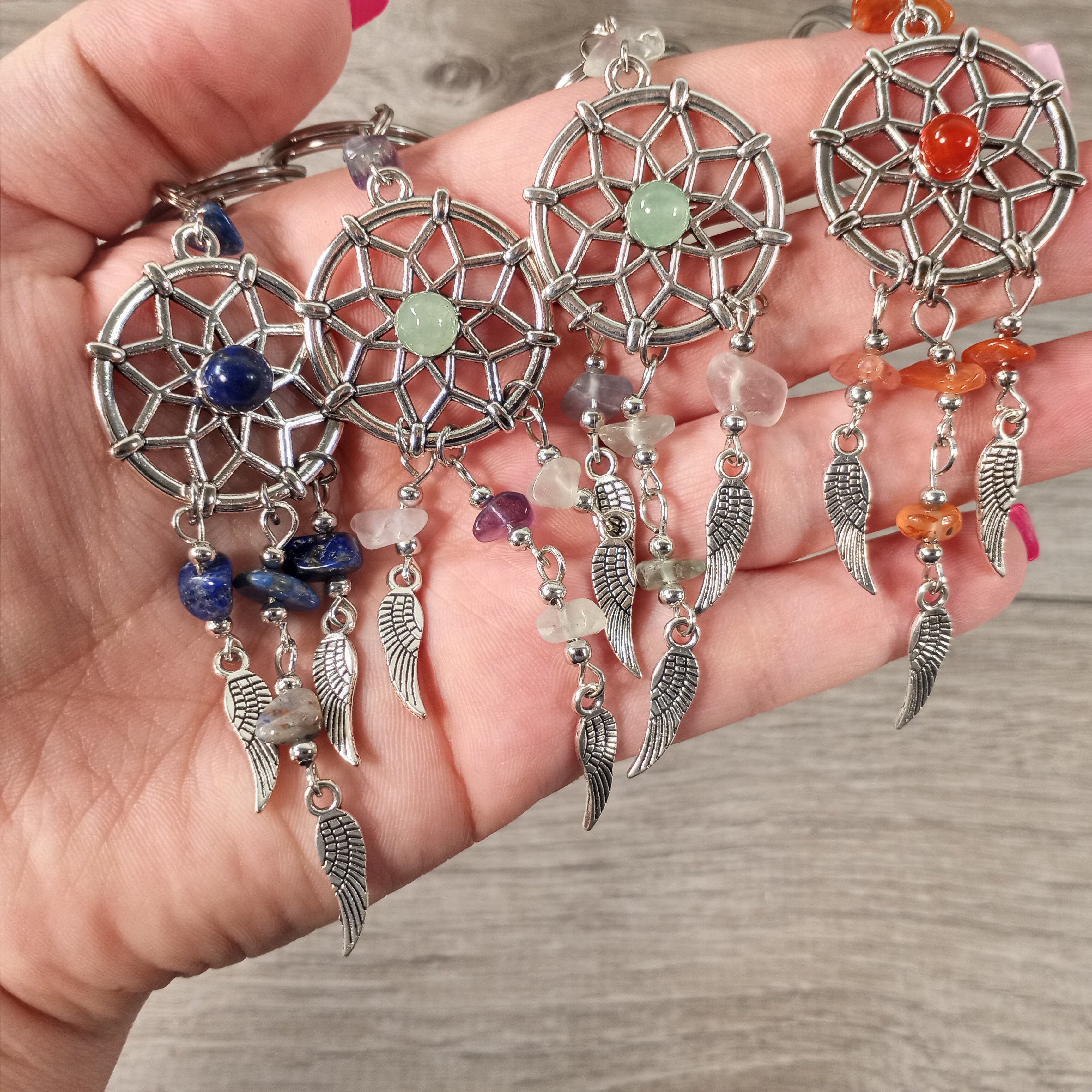 Assorted dreamcatcher keychains with gemstones on display for wholesale buyers