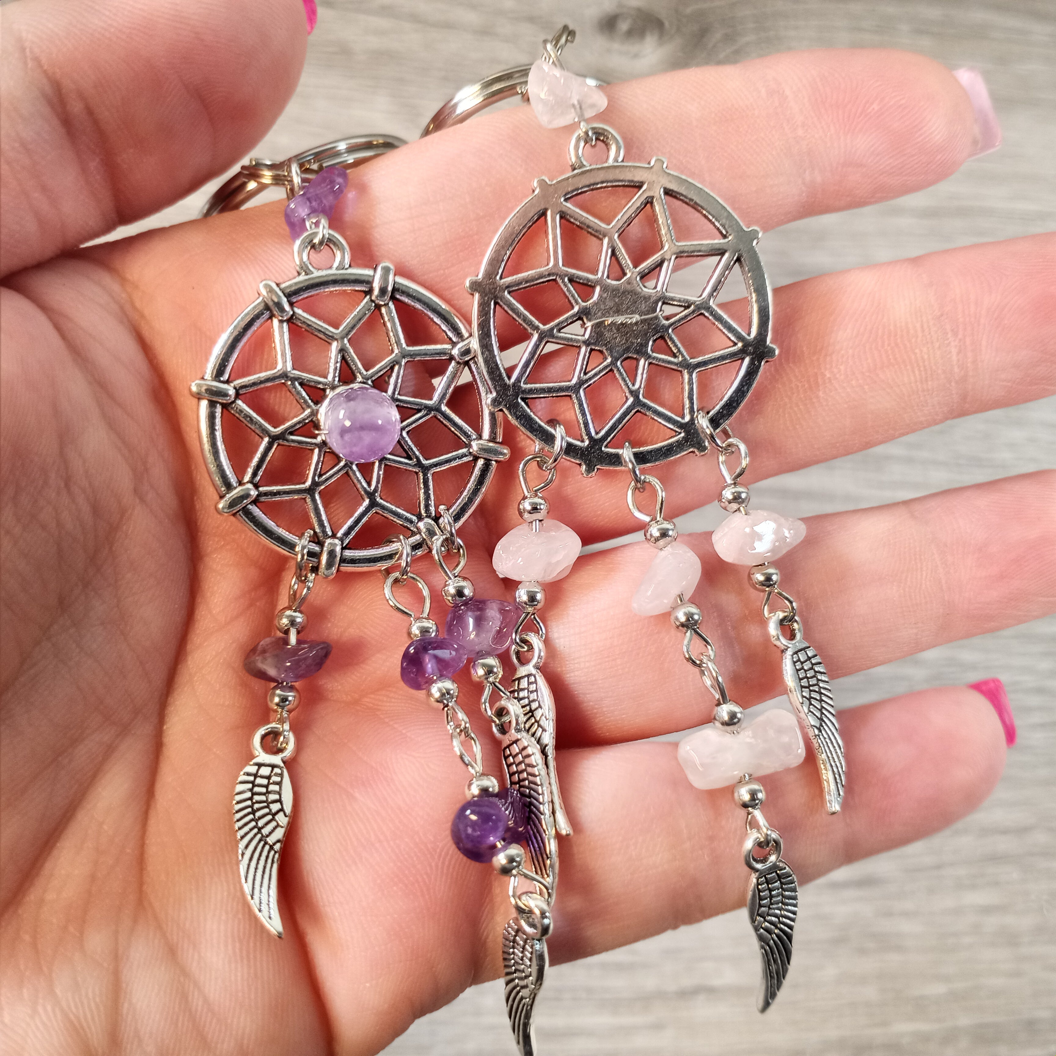 Close-up of a gemstone dreamcatcher keychain with feather accents for boho decor
