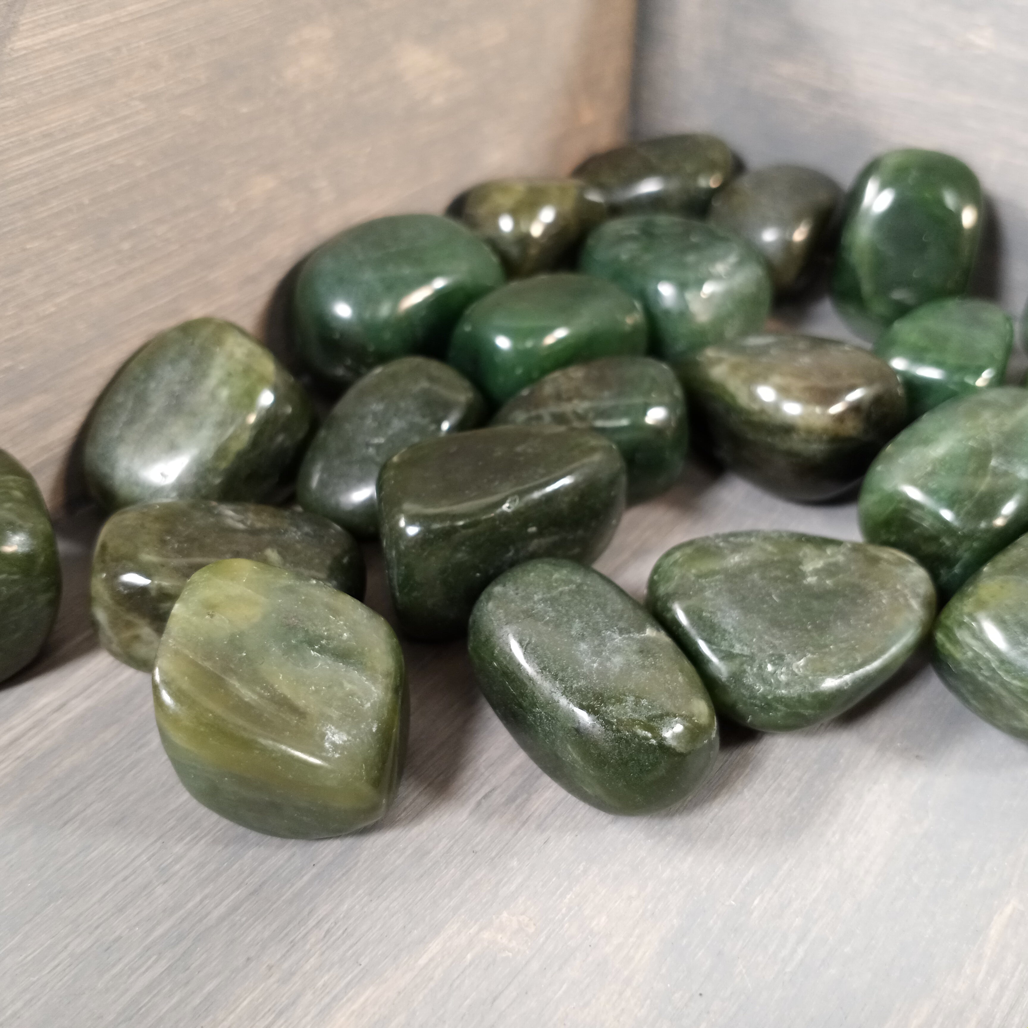 BC Jade tumbled stones in bulk, smooth green jade crystals for retail and energy work