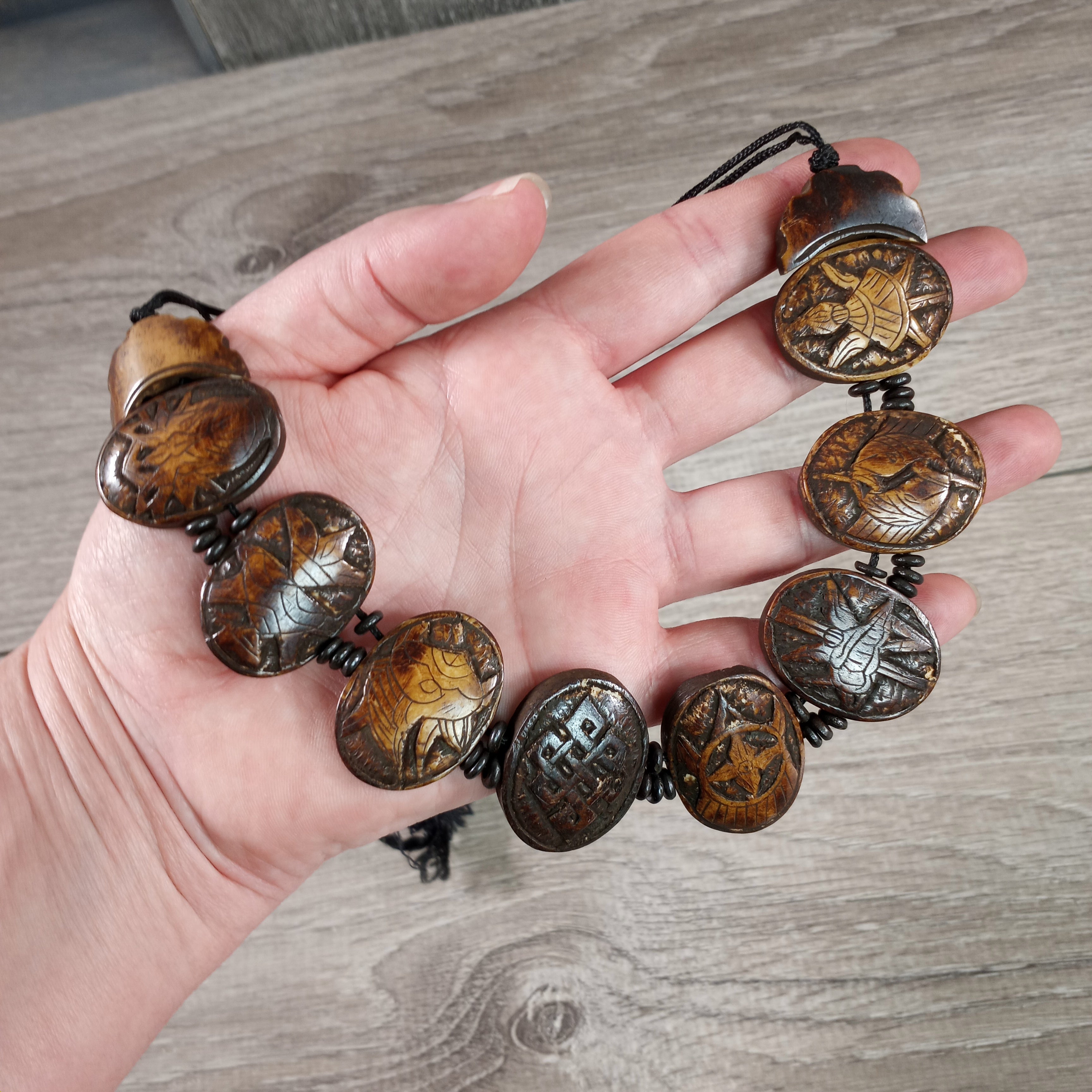 Bone necklace featuring Eight Auspicious Symbols of Tibetan Buddhism