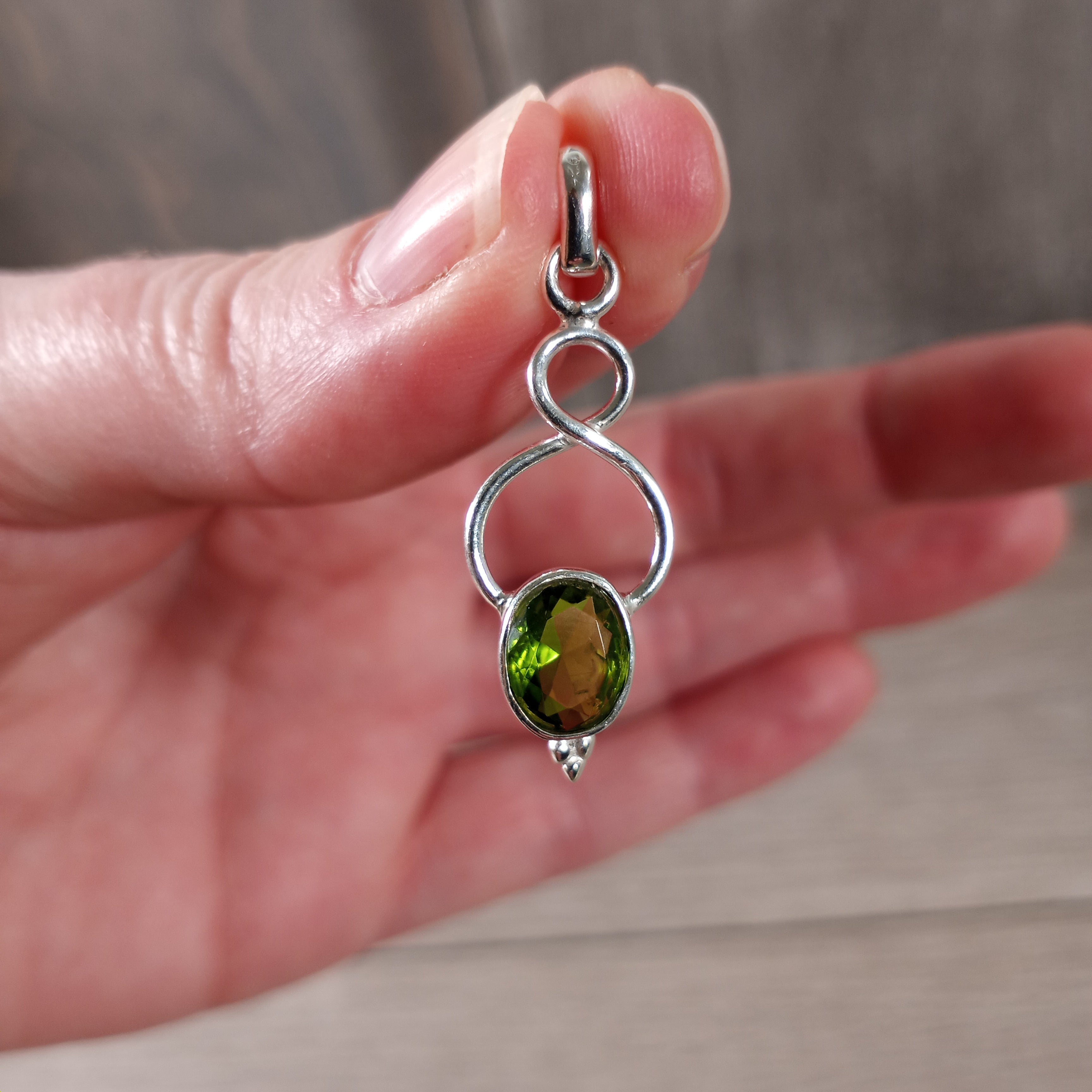 Peridot crystal jewelry pendant for spiritual boutiques