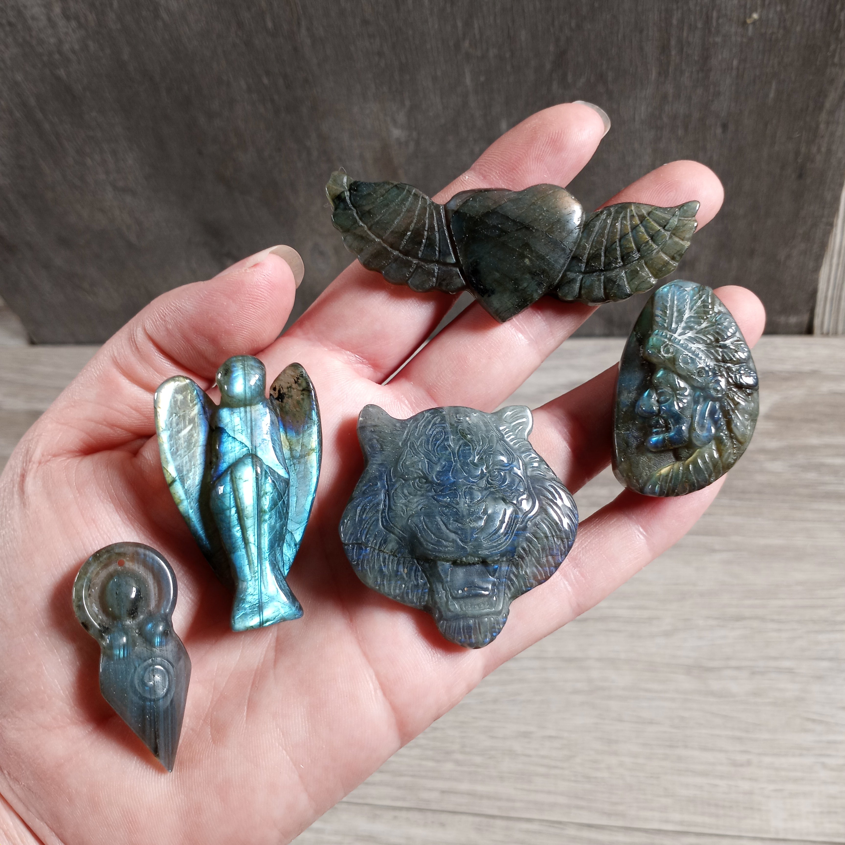 Hand-carved labradorite figurine with iridescent blue and green flashes