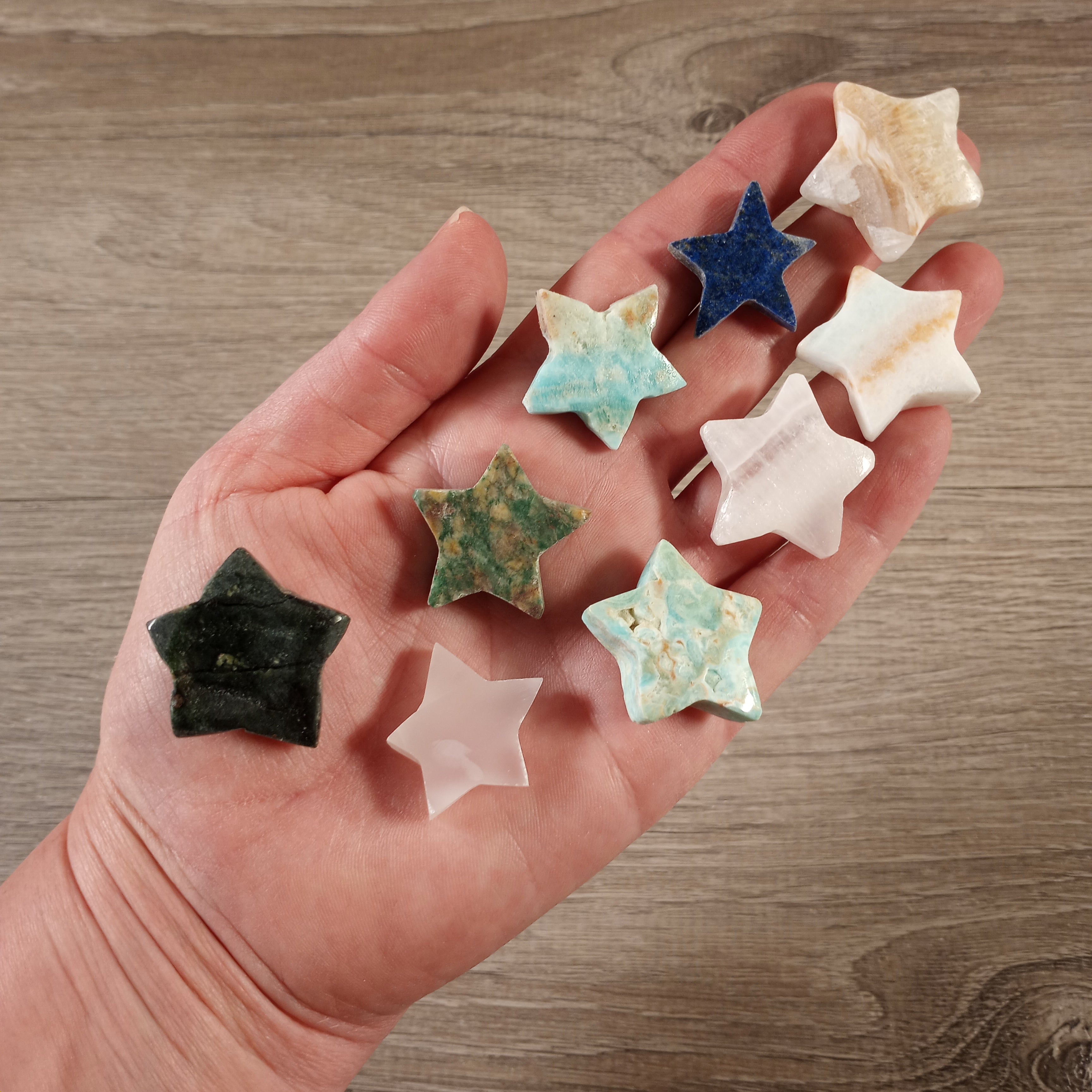 Hand-carved gemstones from Afghanistan featuring Star Pink Calcite, Lapis Lazuli, Nephrite Jade, Caribbean Calcite, and Blue Aragonite in bulk