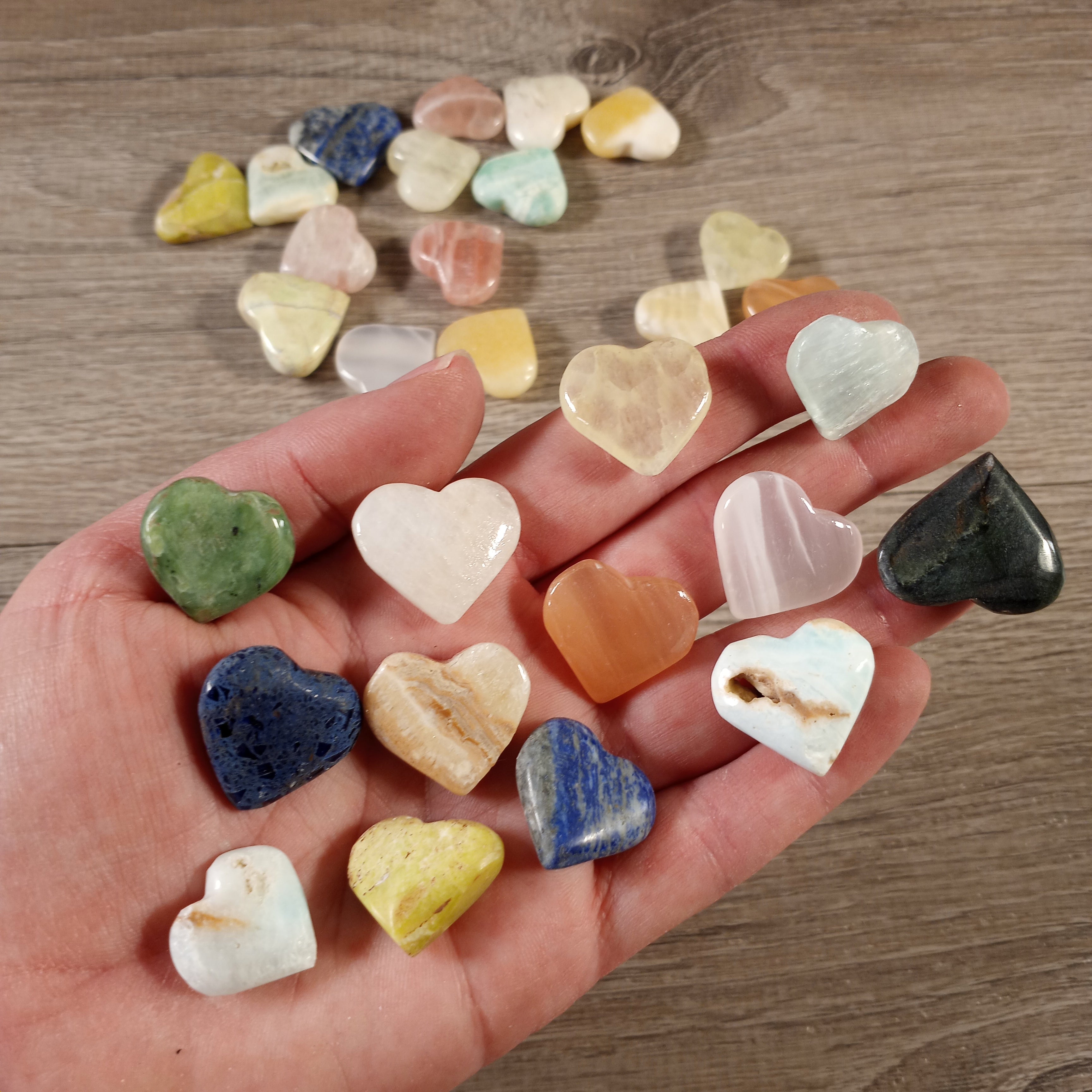 Small hand-carved gemstone heart in assorted crystal types