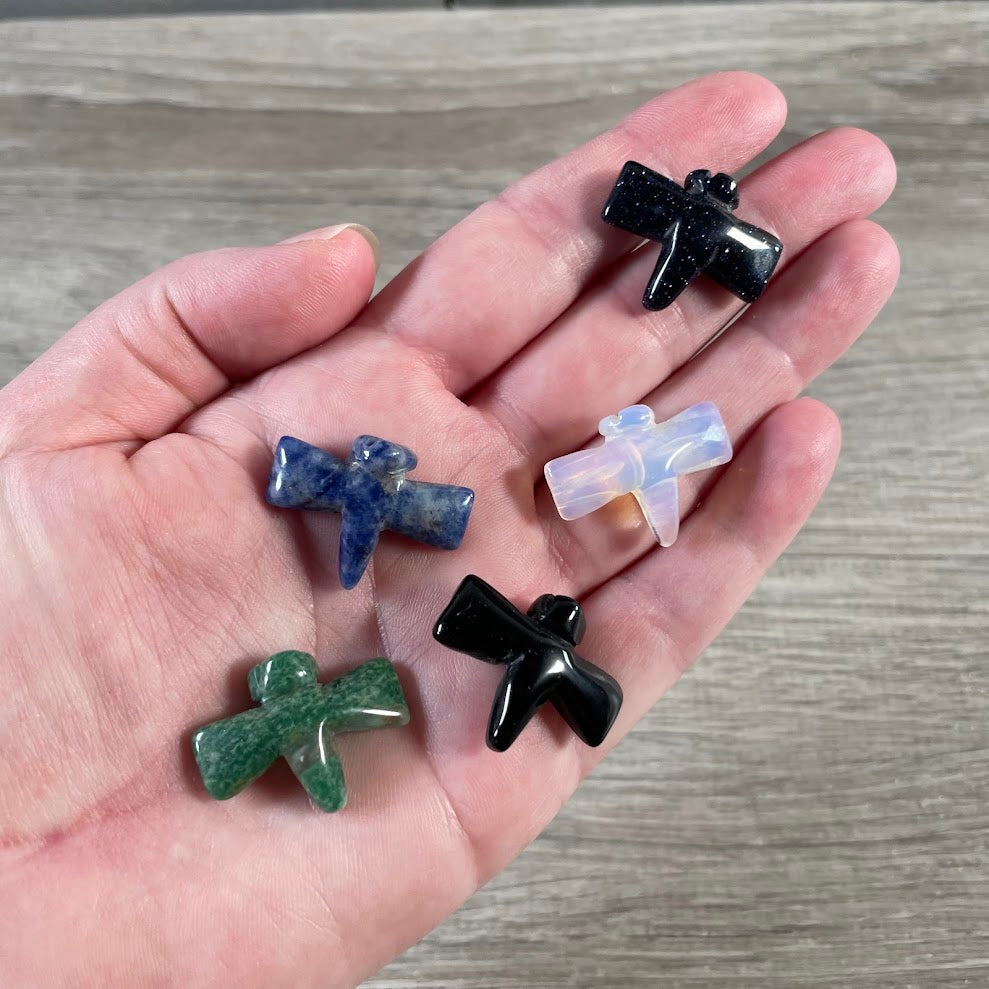 Small carved crystal dragonfly figurines in assorted natural gemstones for gift shops