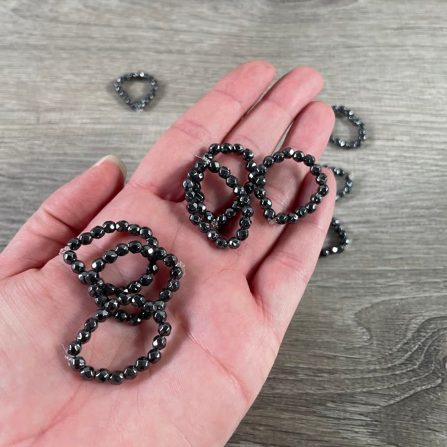 Polished hematite ring display for crystal wholesalers