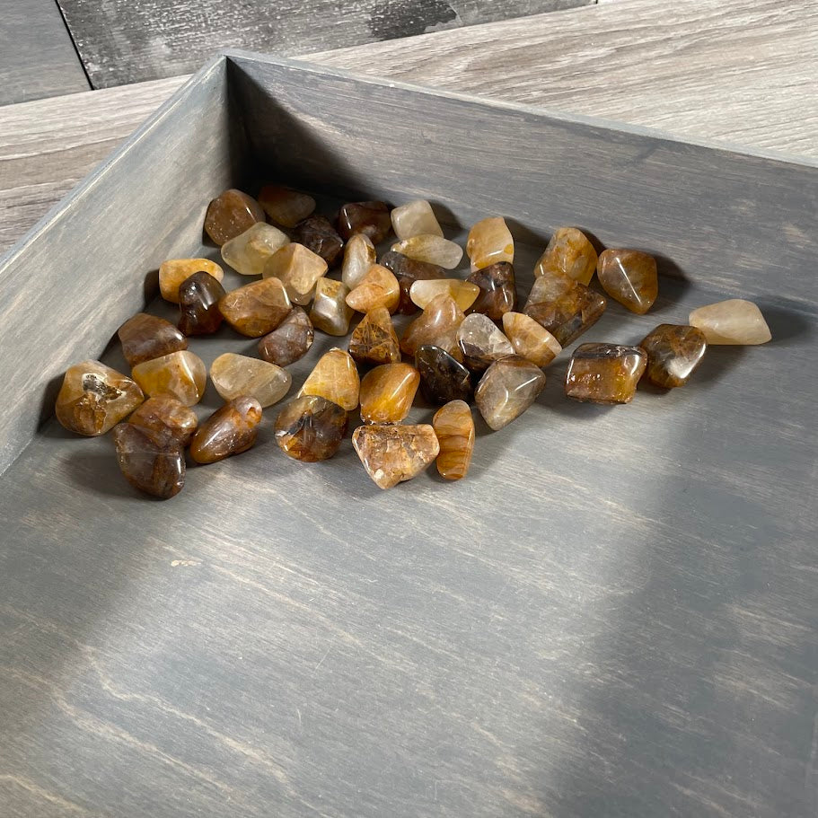 Close-up of Golden Healer tumbled stones wholesale