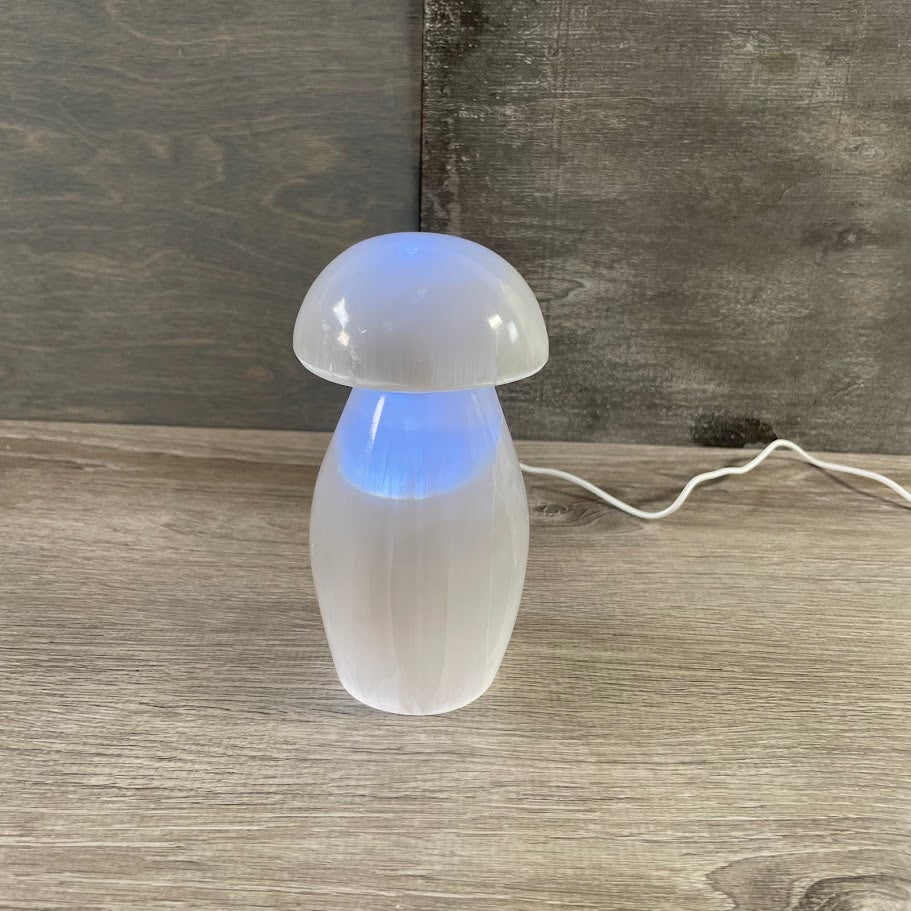 Selenite mushroom lamp glowing with warm light