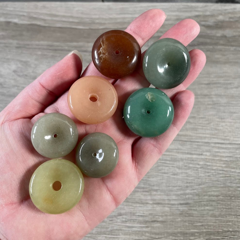 Assorted gemstone donut pi stones in mixed sizes and natural colors for wholesale crystal retailers
