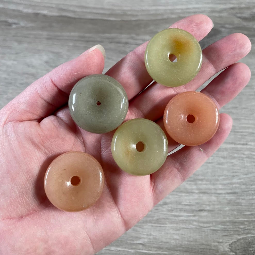 Mixed gemstone donut pi stones with center holes for crystal shops, jewelry makers, and gift stores