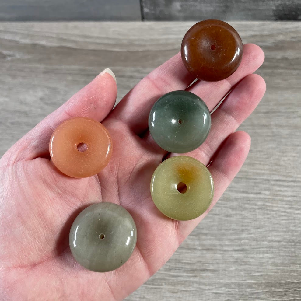 Mixed color gemstone donut stones with unique natural patterns and polished round shapes