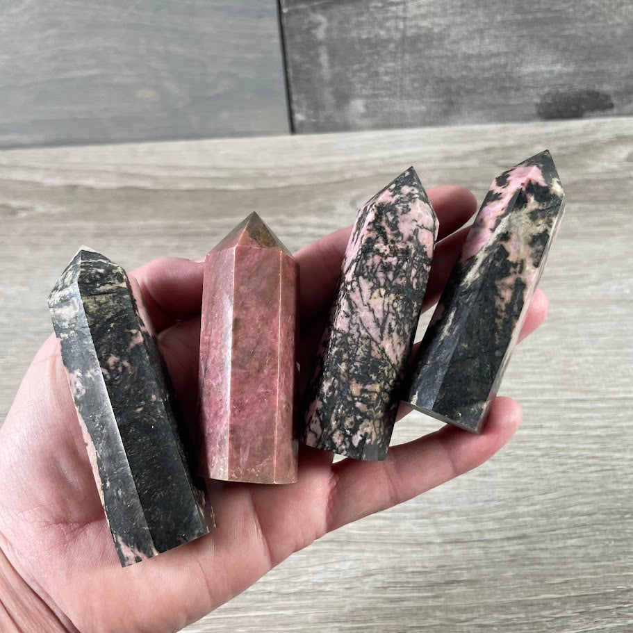 rhodonite crystal obelisk energy healing stone display for rock shops