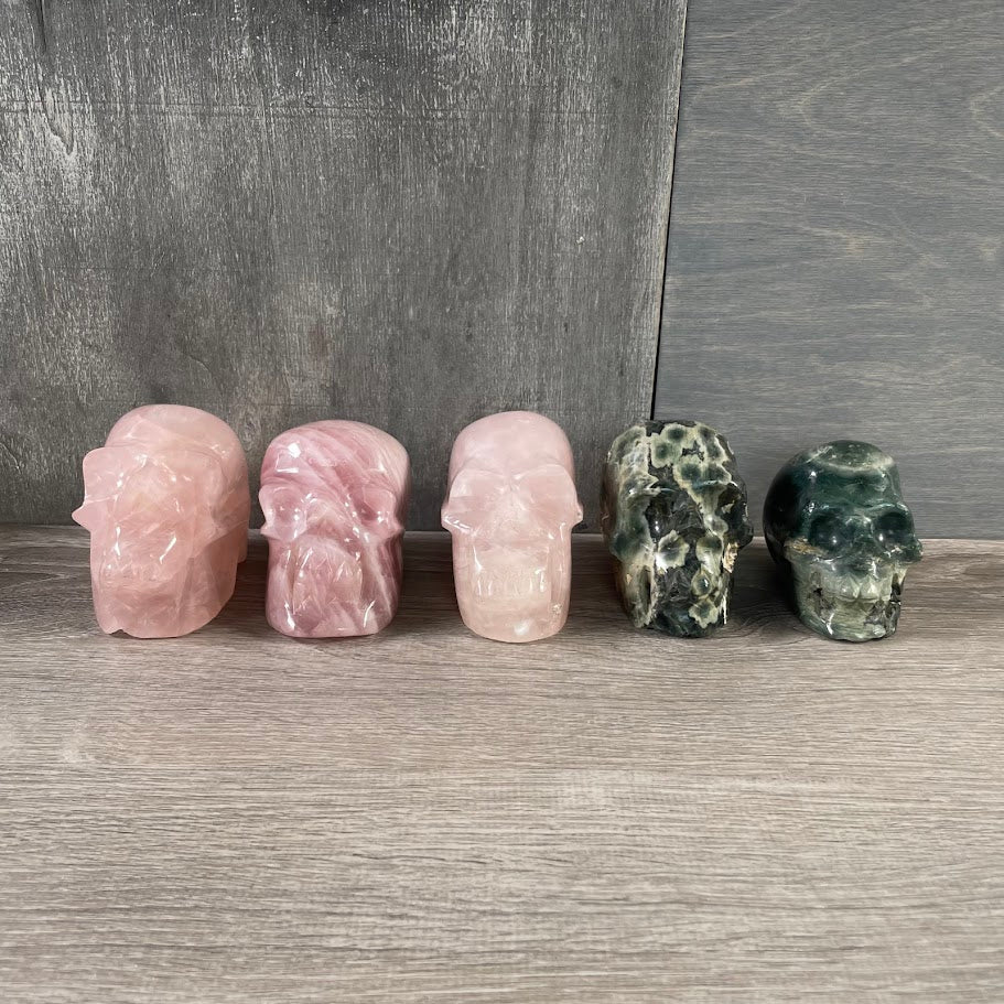 Lot of three rose quartz and two Kambaba jasper skulls,large crystals