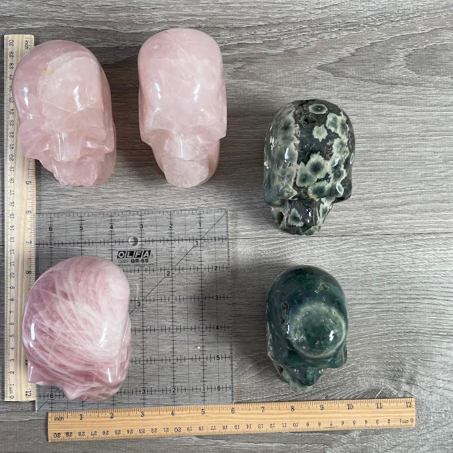 Lot of 5 crystal skulls; three rose quartz and two Kabamba jasper. bulk figurines