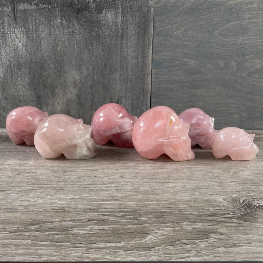Lot of six rose quartz skulls, facing sideways.