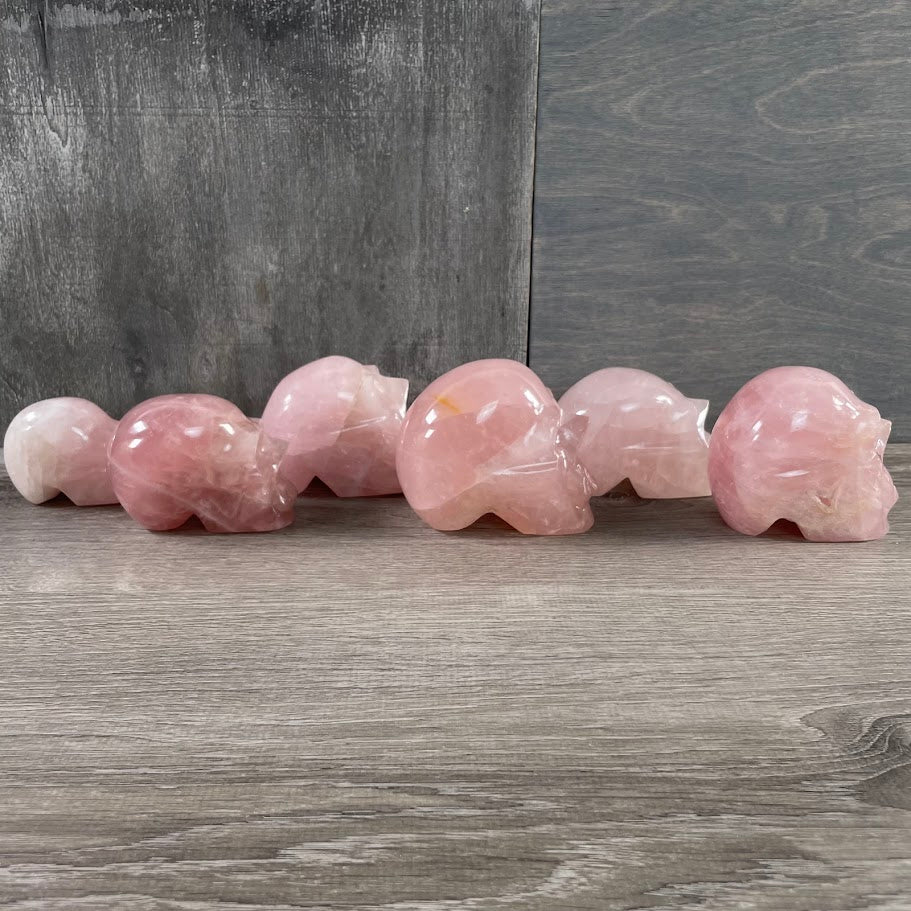 Lot of six rose quartz skulls, facing sideways.