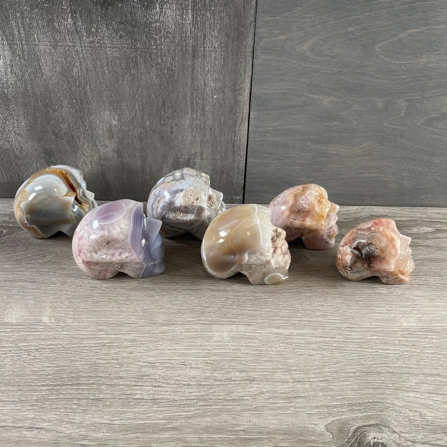 Lot of three quartz and three agate skulls; facing sideways.