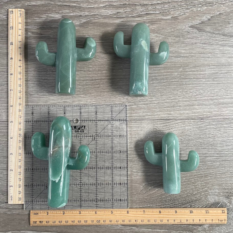Four aventurine cacti with grid and rulers for size reference.