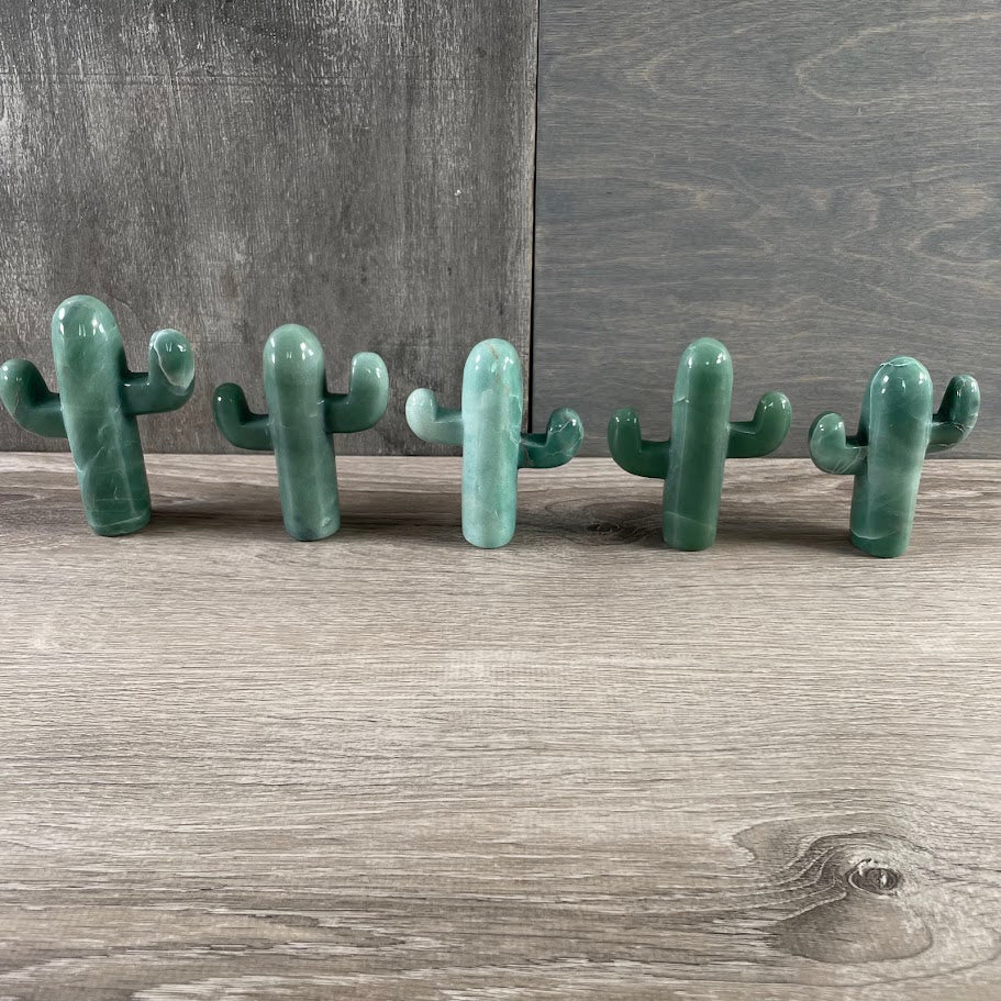 Five aventurine cacti standing.