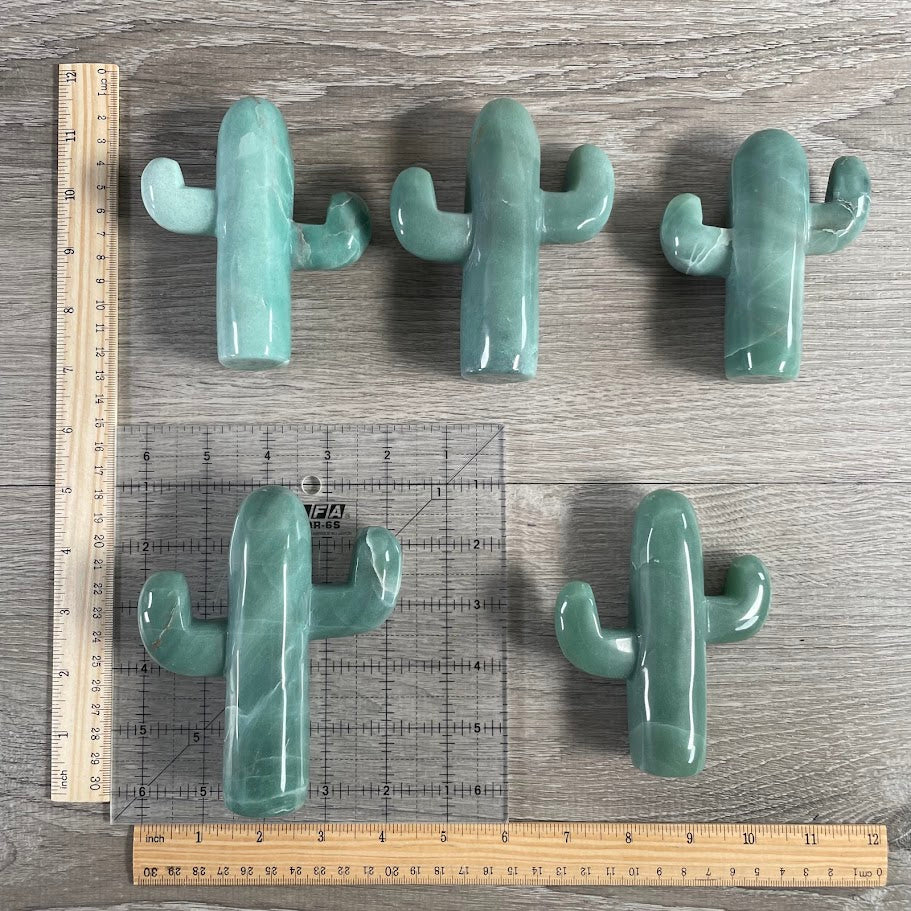 Five aventurine cacti with grid and rulers for size reference.