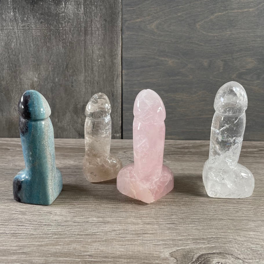 Four front-side standing gemstone penis's: 2 quartz, 1 trollite, 1 rose quartz.