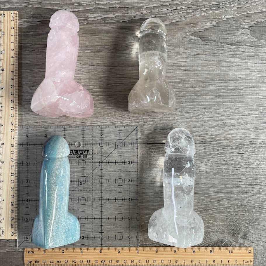 Four Gemstone Penis Figurines: 2 quartz, 1 trollite and 1 rose quartz, with rulers and grid for size reference.