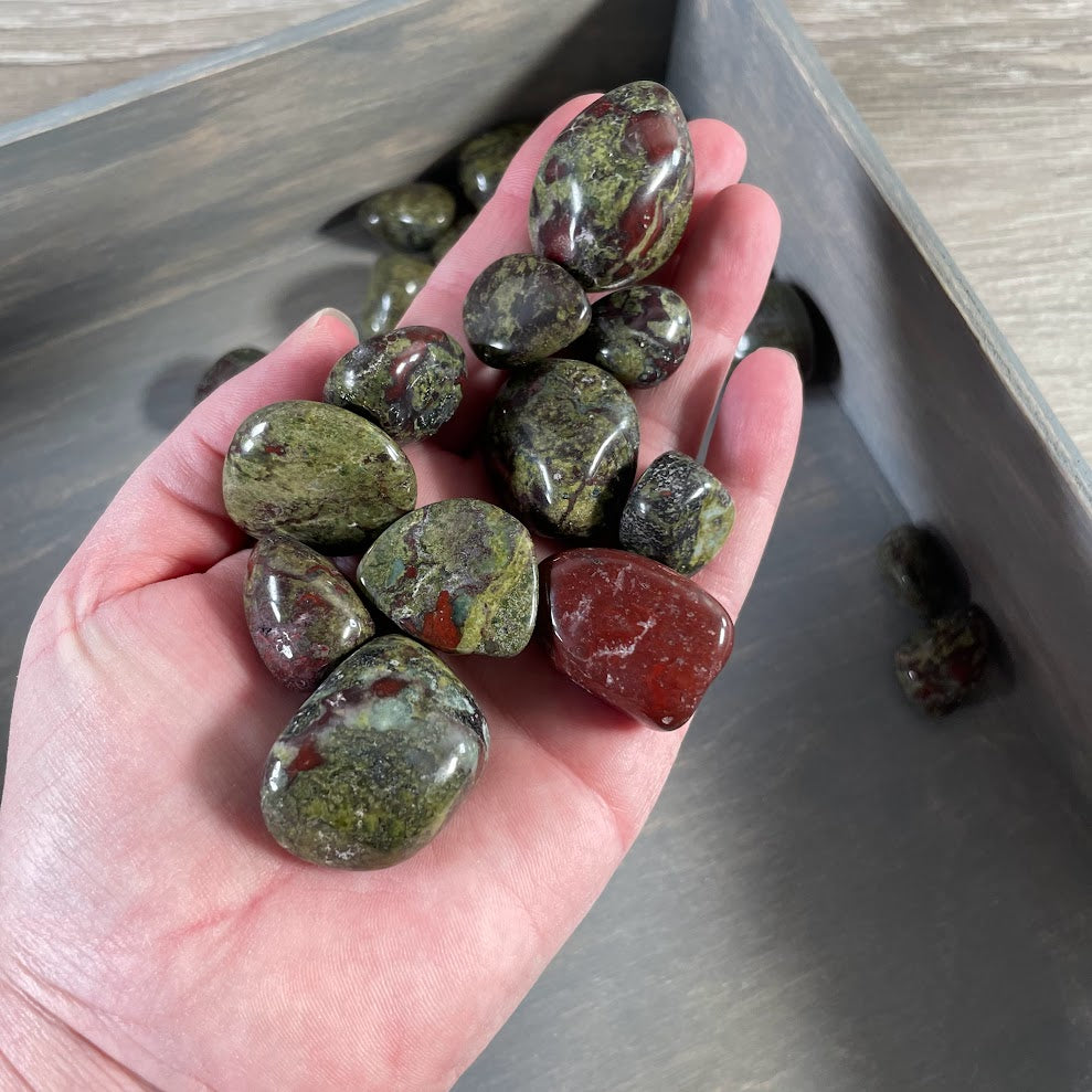 Close up of polished Dragon Bloodstone tumbled stones for crystal shop inventory