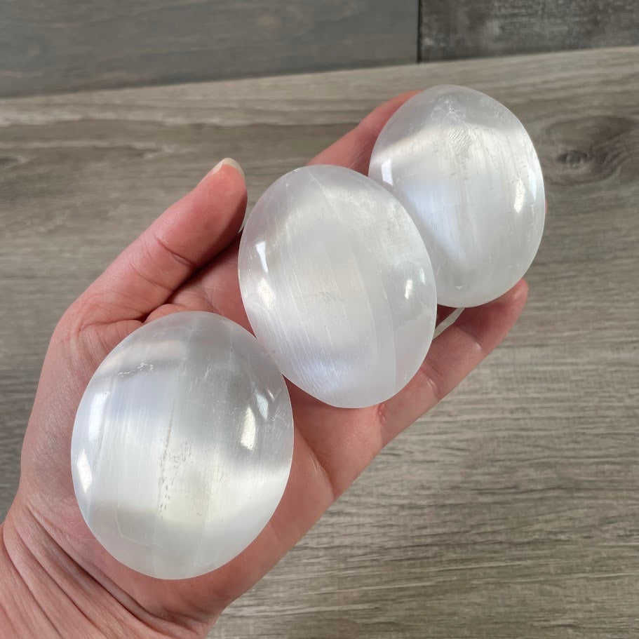 Polished Selenite crystal palm stones in bulk for metaphysical shops