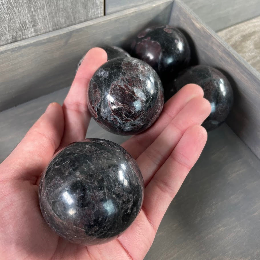 Astrophyllite with garnet spheres natural gems for resalers.