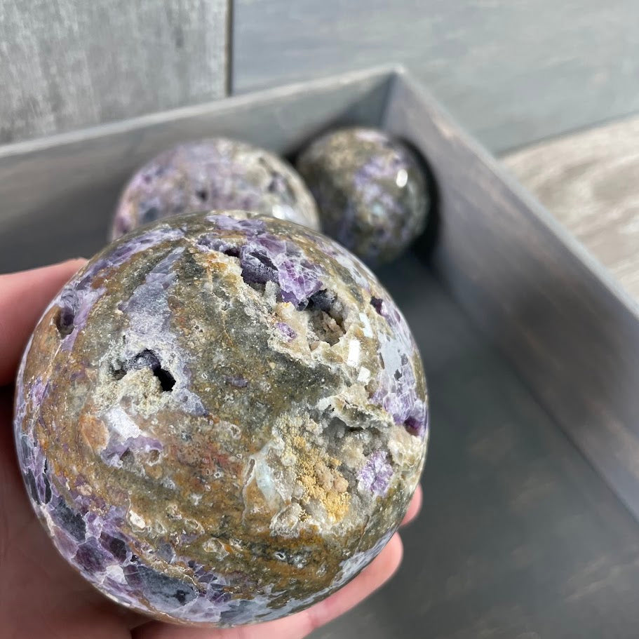 Lot of three fluorite vug spheres; bulk purchase.