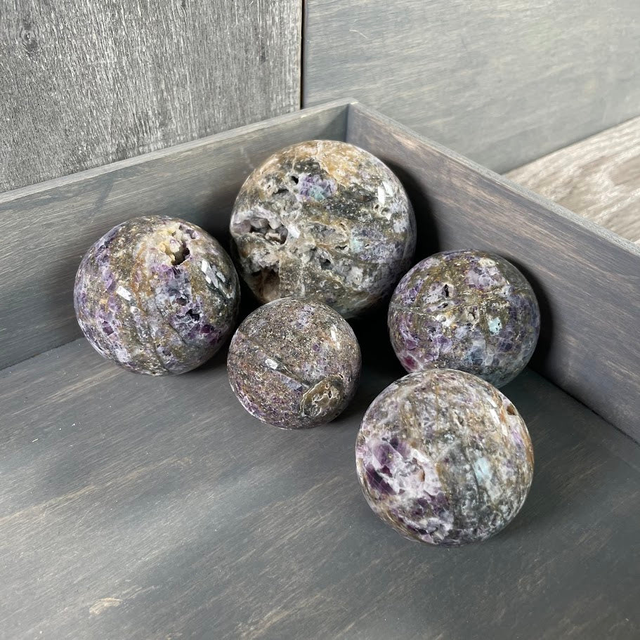 Lot of five fluorite vug spheres for wholesale.