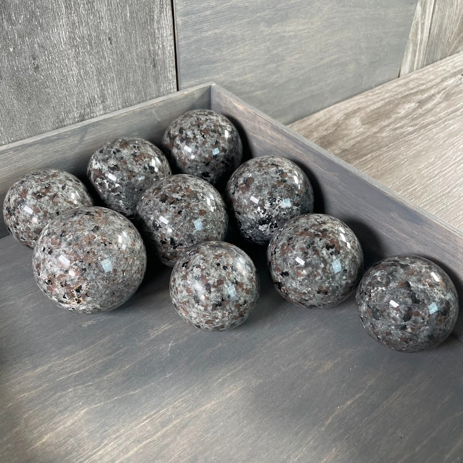 Lot of nine flame stone spheres.