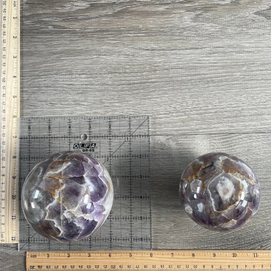 Lot of two amethyst sphere with grid and rulers for size reference.
