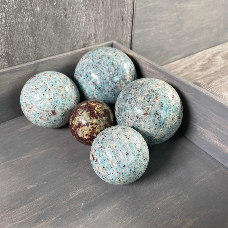 Amazonite with biotite Large and small gemstone spheres for energy work