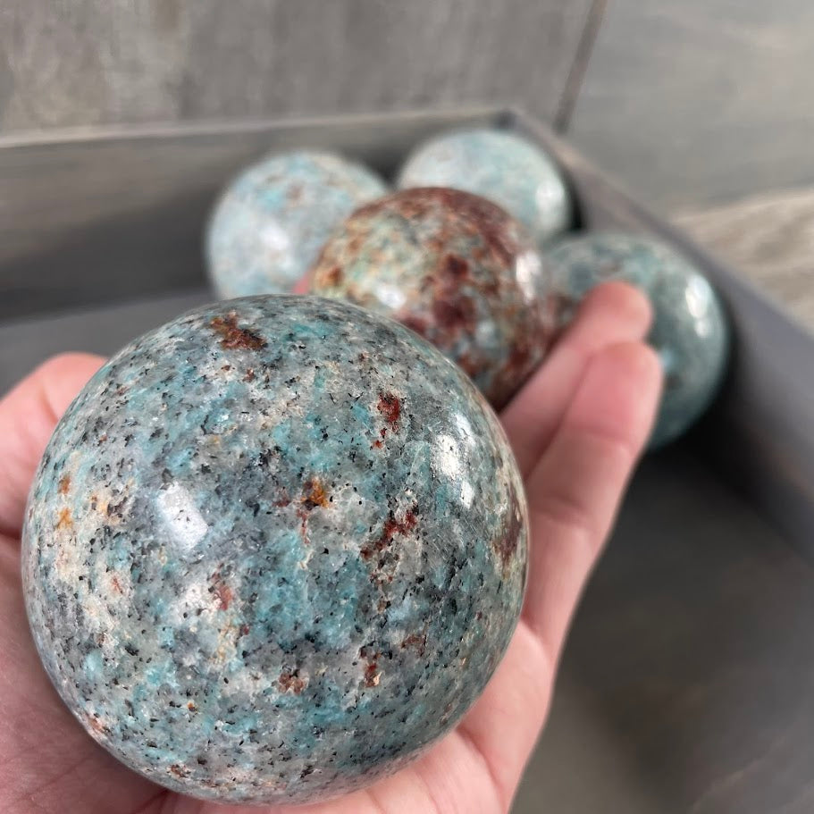 Close up of amazonite with biotite spheres for collectors.