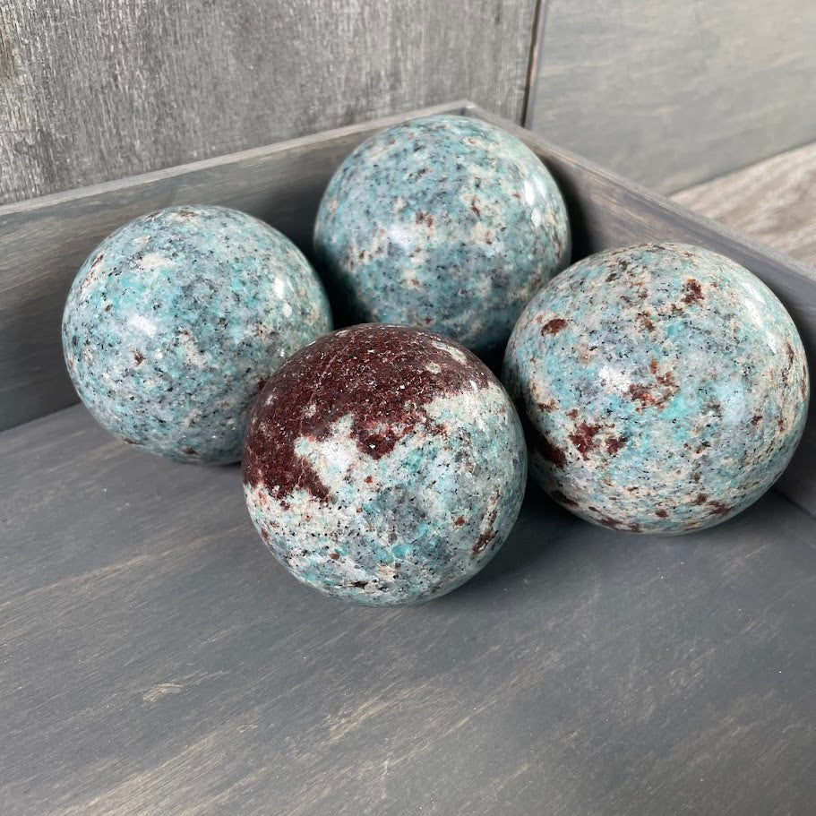 Lot of four amazonite with biotite spheres.