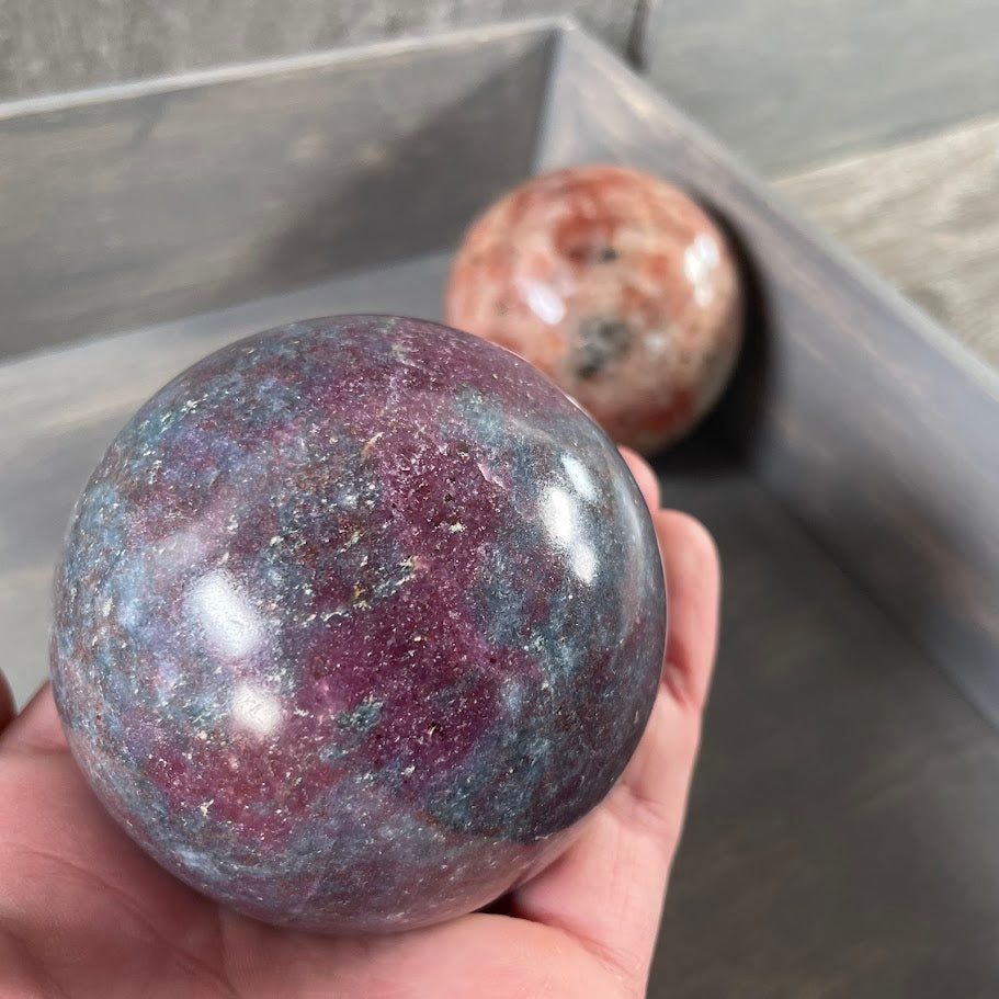 Ruby in kyanite and sunstone sphere for metaphysical healing stores.