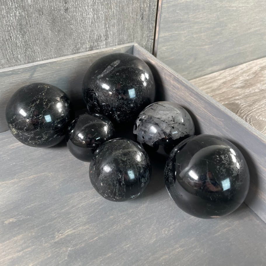 Black tourmaline spheres sold in bulk.