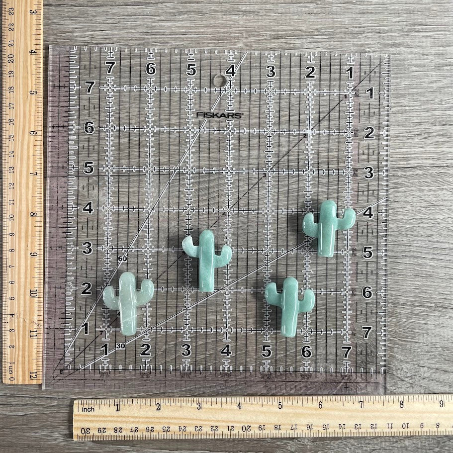 Four aventurine cacti with grid and rulers for size reference (cacti ~1.5inch long).