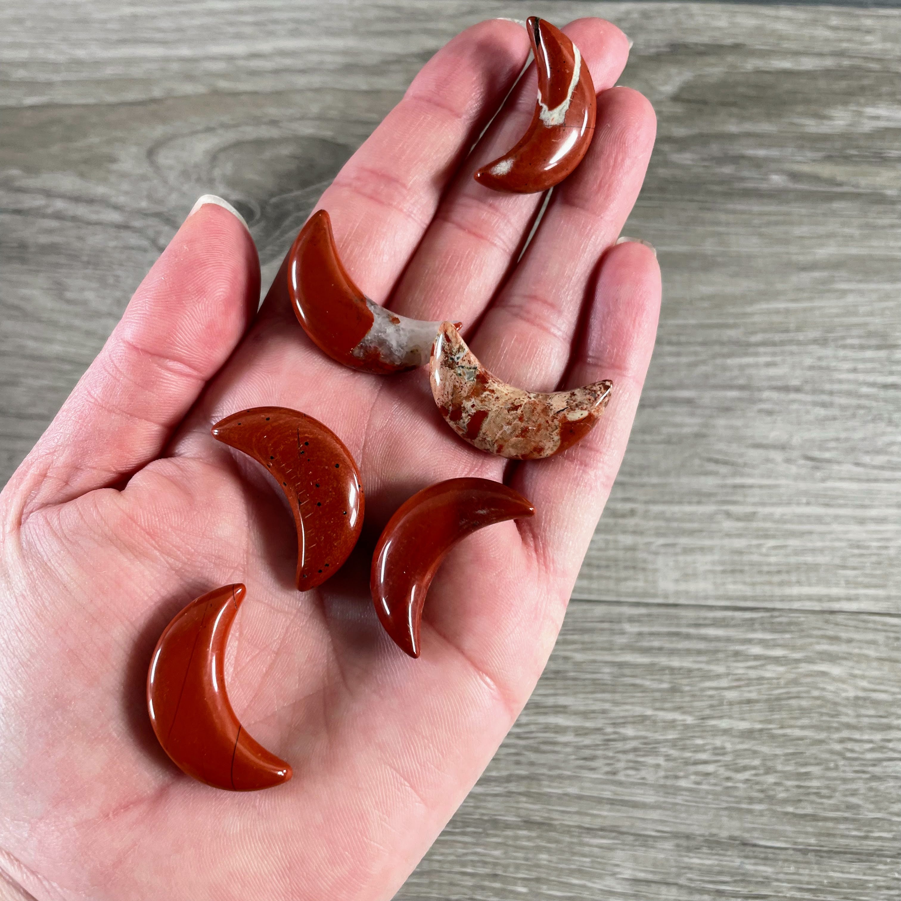 Red Jasper crystal crescent moon carvings for altar displays