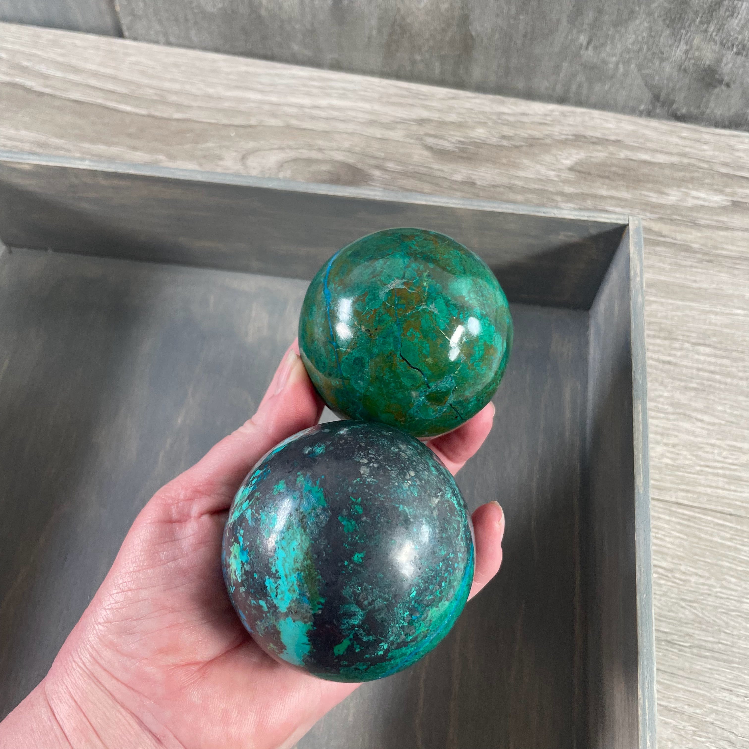 Polished Chrysocolla gemstone spheres in vibrant blue-green hues