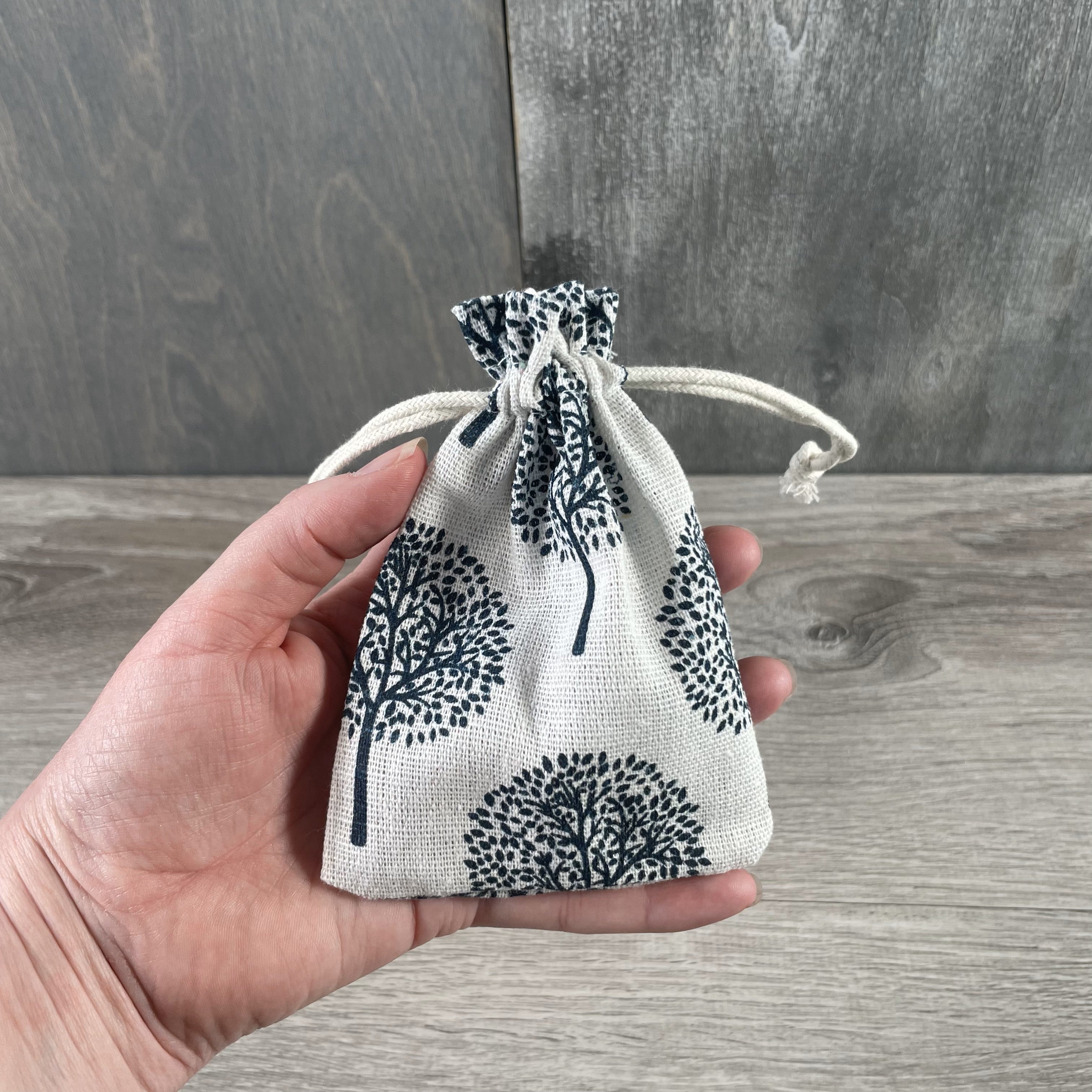 Wholesale natural burlap pouch featuring Tree of Life design for gift packaging