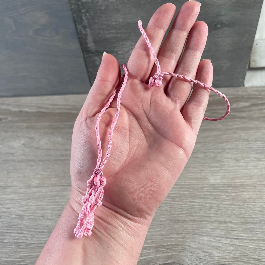 Pink crystal cage necklace displaying removable gemstone