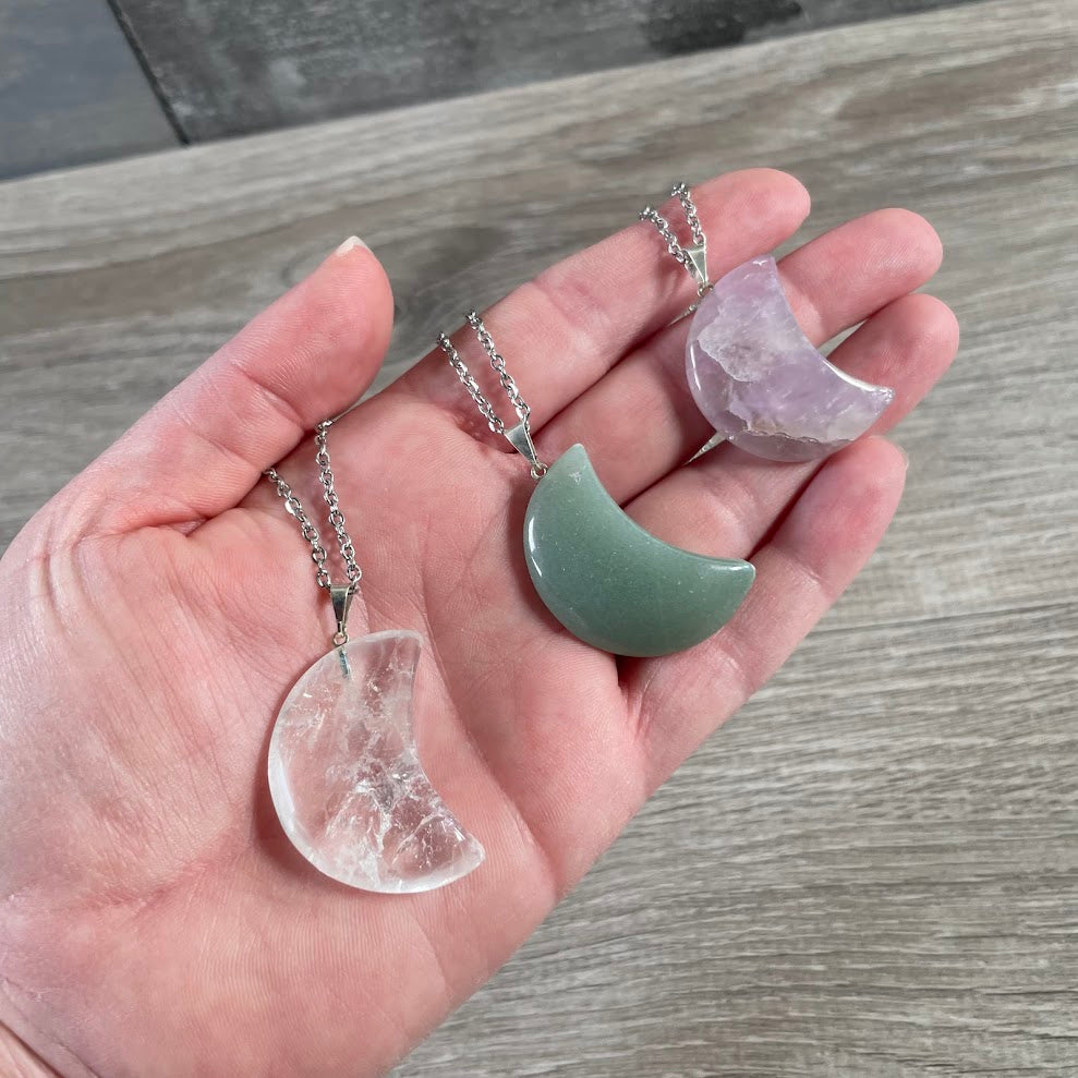 Assorted crescent moon crystal pendants on stainless steel chain