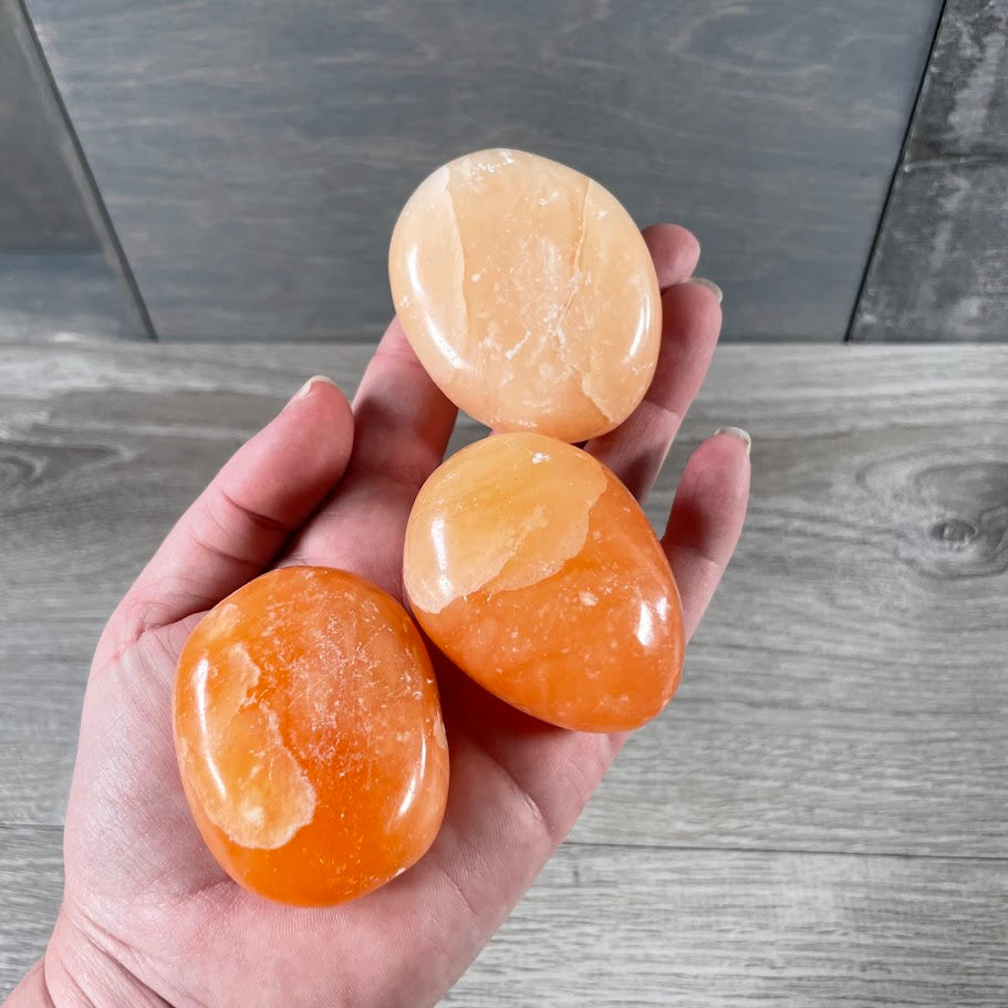 metaphysical shop supplies, orange calcite palm stones