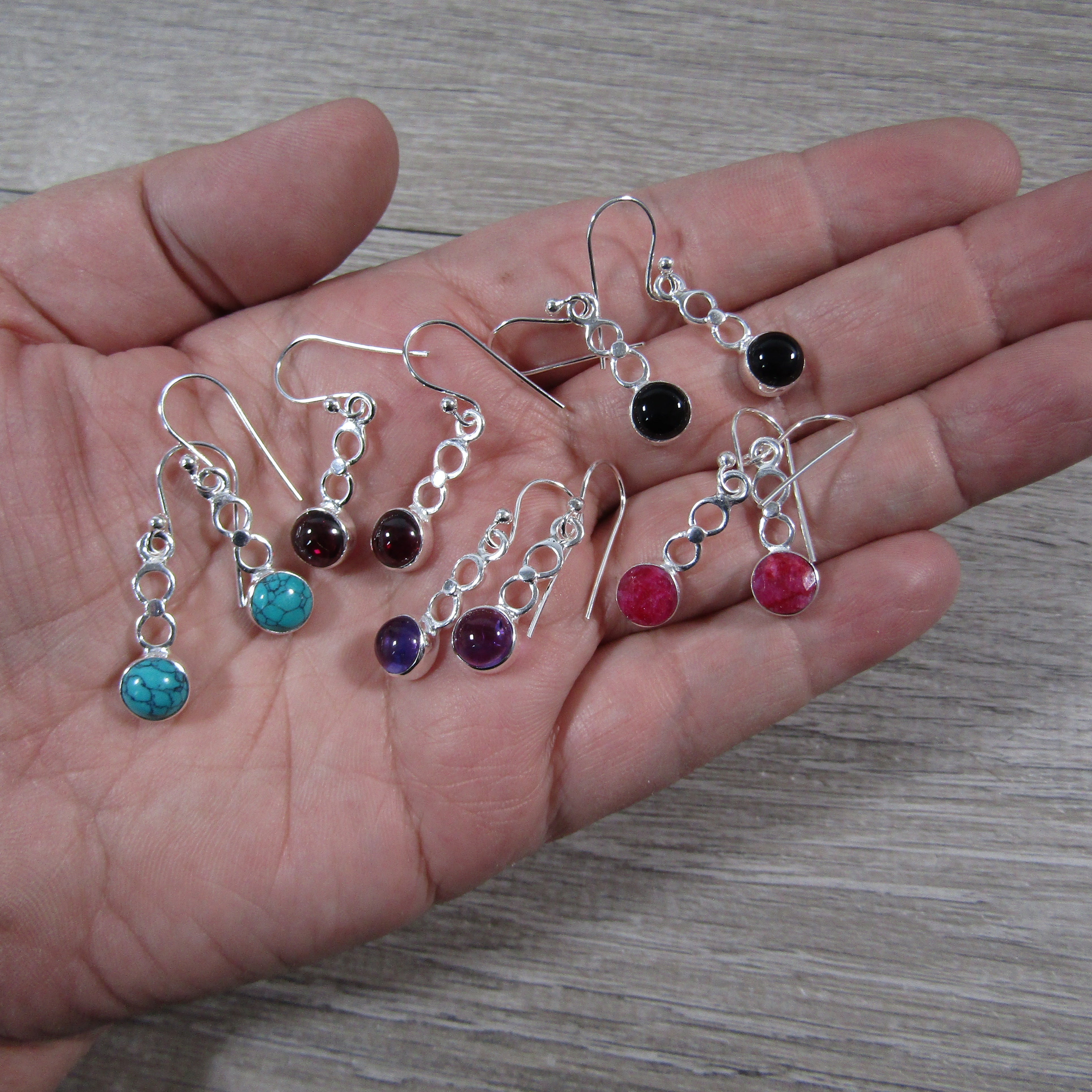 Drop earring in assorted stones.